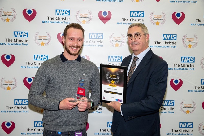 A photo of George Stewart receiving his Christie Colleague Award from Christie Chief Executive Roger Spencer.