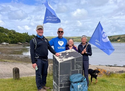 A photo of Professor Nick Slevin and Peter Walker with their partners Carrie and Helen completing the Pembrokeshire Coast Path trek.