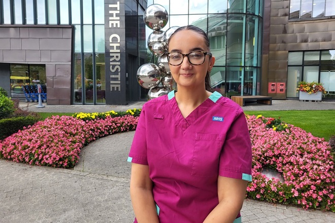 A photo of Christie radiographer Suzanne Lagan standing outside the main entrance to The Christie.