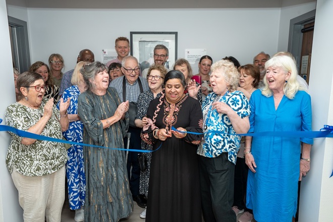 A photo of a large group of people at the ribbon cutting ceremony for the art room at The Christie.