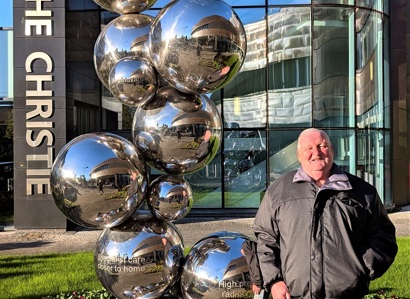 A photo of Christie patient William Bennett outside The Christie in Withington.