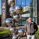 A photo of Christie patient William Bennett outside The Christie in Withington.