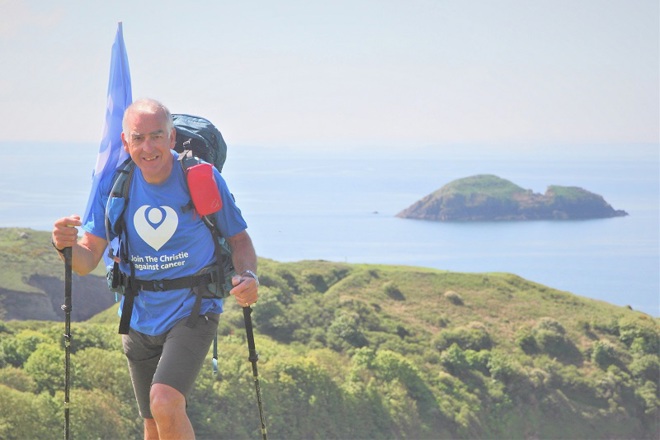 A photo of Peter Walker, walking the Pembrokeshire Coast Path to raise money for The Christie Charity.