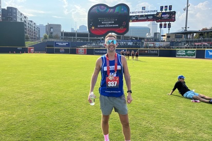 A photo of Christie Charity fundraiser Alan Lea wearing a medal after completing the Nashville marathon.