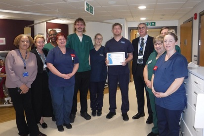 A photo of Daniel Faulkner, clinical educator in chemotherapy services, with the rest of his team and Christie Chief Executive Roger Spencer as he is presented with his award as the winner of The Christie’s You Made a Difference Award for September 2024.