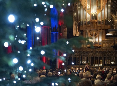 A photo of Manchester Cathedral; the pipe organ can be seen in the background, with a Christmas tree in the foreground.