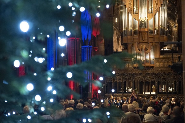 A photo of Manchester Cathedral; the pipe organ can be seen in the background, with a Christmas tree in the foreground.