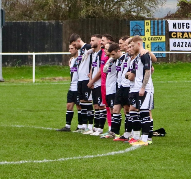 A photo of the men from the West Didsbury and Chorlton FC team standing on the pitch.