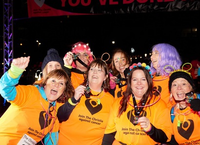 A photo of a group of women showing medals to the camera at The Christie Charity Night of Neon event.