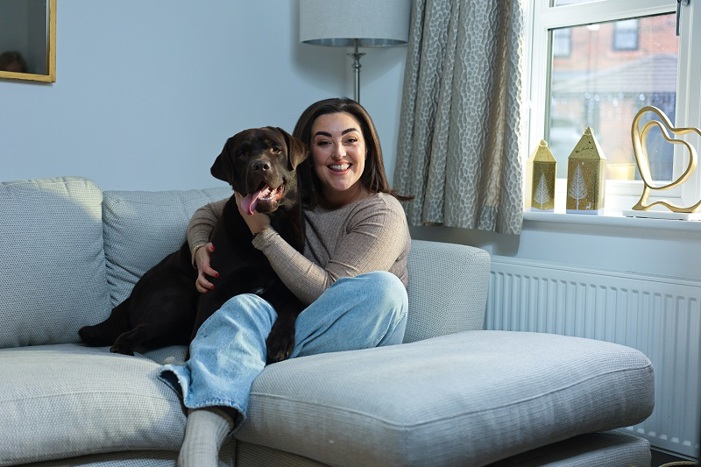 A photo of Christie patient Bianca Perea with her labrador dog Cubby.