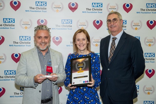 A photo of Dr. Richard Berman receiving his Christie Colleague Award from Christie Chief Executive Roger Spencer and his patient, Helen Hyndman.