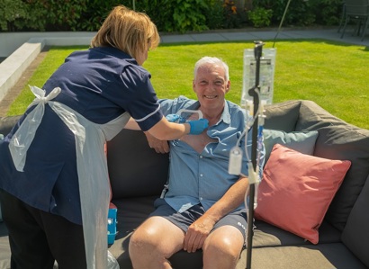 A photo of Christie patient Des Burns having the 50000th treatment provided by The Christie's at home service since 2015.