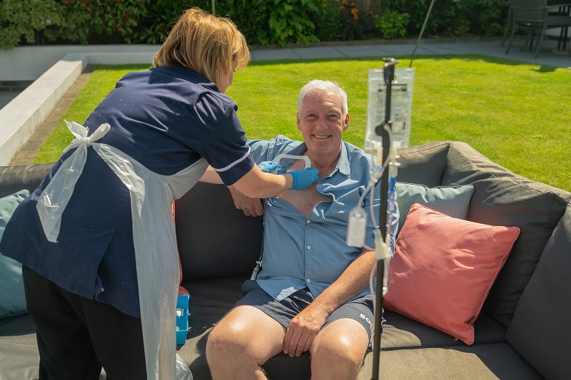 A photo of Christie patient Des Burns having the 50000th treatment provided by The Christie's at home service since 2015.