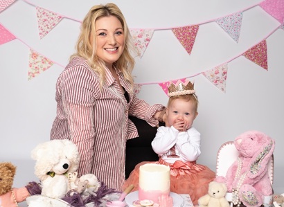 A photo of Christie patient Laura Hudson and her baby Aurora at a tea party.