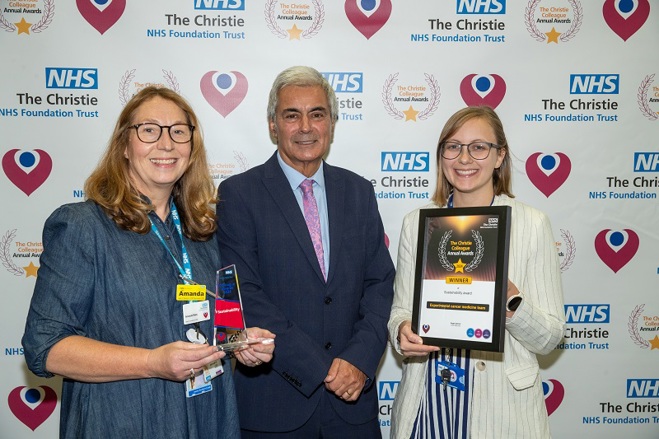 A photo of the experimental cancer medicine team at The Christie receiving their Christie Colleague Award from Christie Non-executive Director Tarun Kapur.