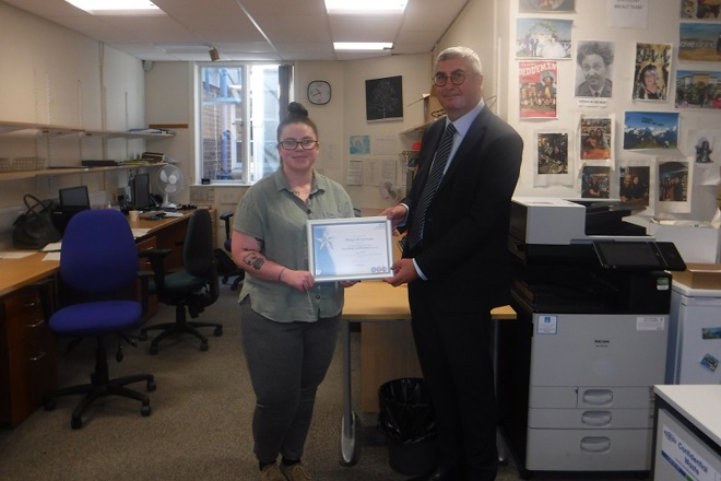 A photo of Robyn Bowerman, medical secretary in the clinical oncology breast team at The Christie, receiving her You Made a Difference Award for June 2024 from Christie Chief Executive Roger Spencer.