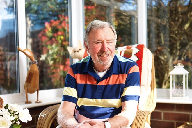 A photo of Christie patient Jeff Cook sitting in a conservatory.
