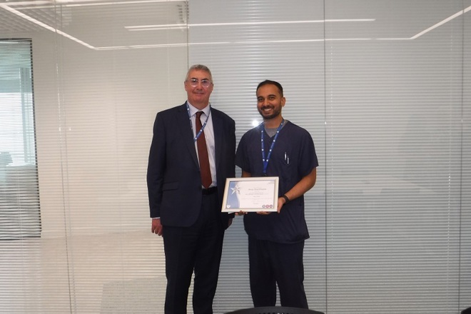 A photo of Anup Shanthappa, senior clinical research nurse in the colorectal research team at The Christie, receiving his You Made a Difference Award for April 2024 from Christie Chief Executive Roger Spencer.