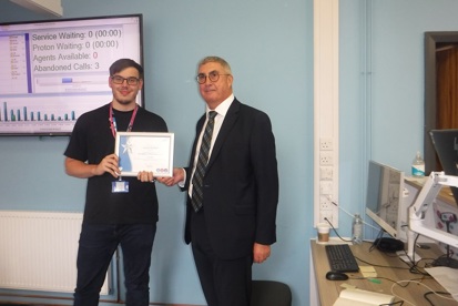 A photo of Lewis McNuff, IT support technician in digital services at The Christie, receiving his You Made a Difference Award for July 2024 from Christie Chief Executive Roger Spencer.