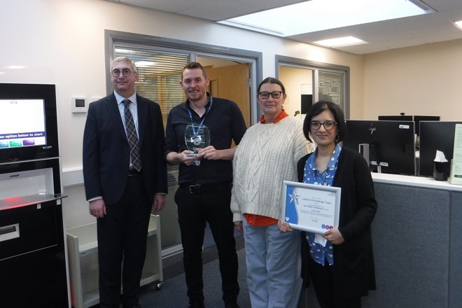 A photo of the Library And Knowledge Team at The Christie and Christie Chief Executive Roger Spencer as the team is presented with their award as the winners of The Christie’s You Made a Difference Award for October 2024.