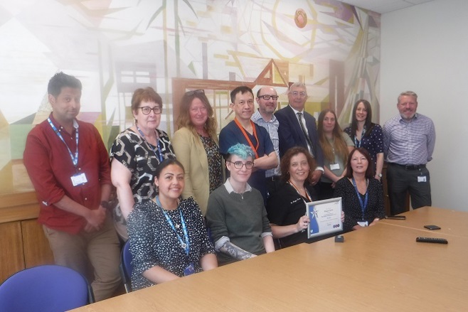A photo of The Christie's You Made a Difference Award winner Maggie Harris with her clinical oncology colleagues and Christie Chief Executive Roger Spencer.