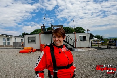 A photo of Christie fundraiser Kat Watson wearing a skydive outfit, a logo in the bottom-right corner reads 'Black Knights Skydiving Centre: No Limits'.